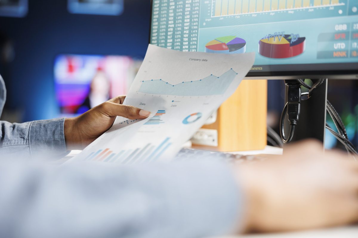 African american consultant studying constitutional balance records and expenditure figures for regular accounting evaluation. Financial expert reviews business budgetary constraints. Close up.