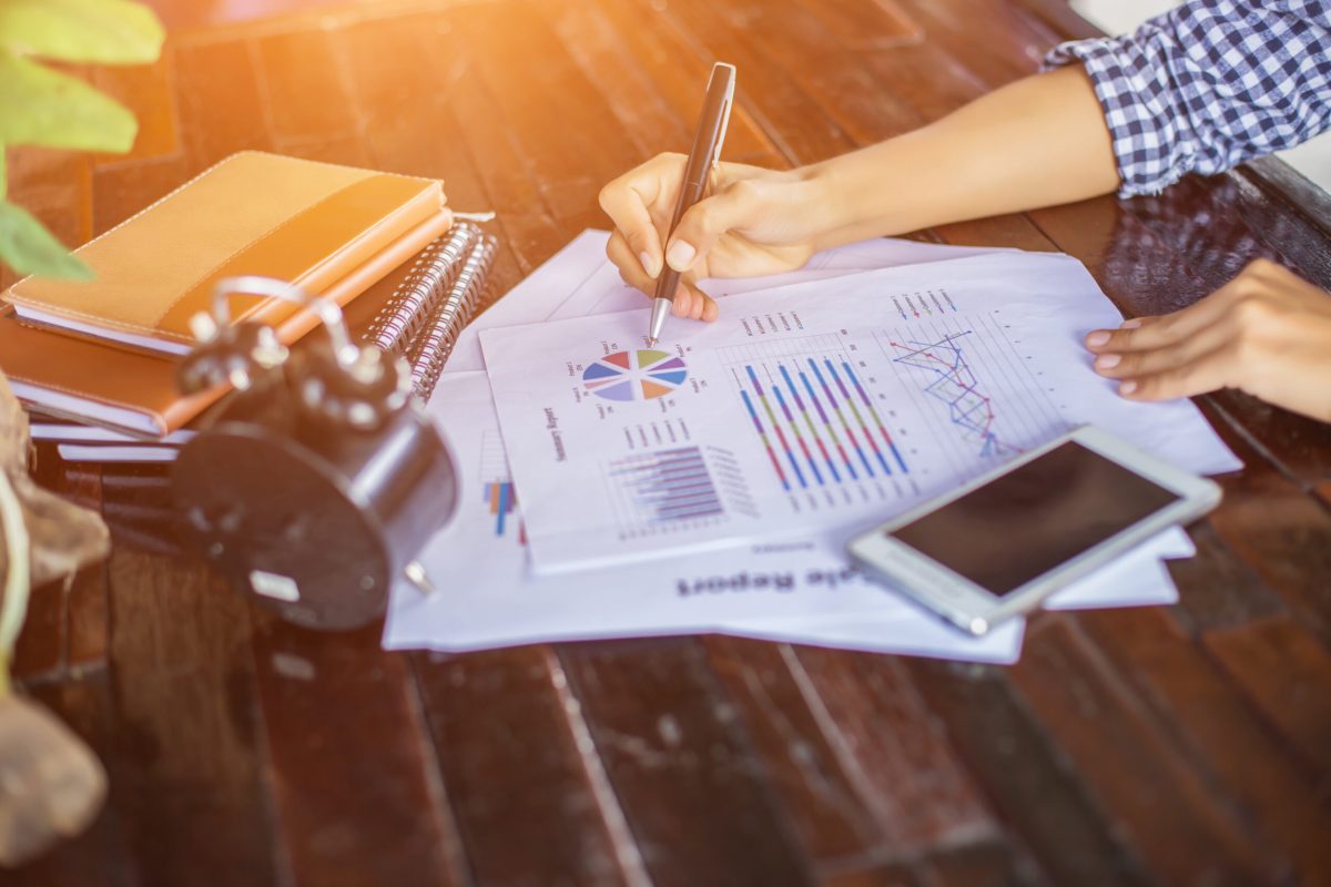 Business team working on laptop, while sitting at office. Business people.