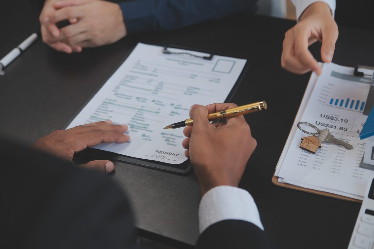 Real estate agent and Sales manager team analysis pricing of rental lease contract of sale purchase agreement, concerning mortgage loan offer for and house insurance.